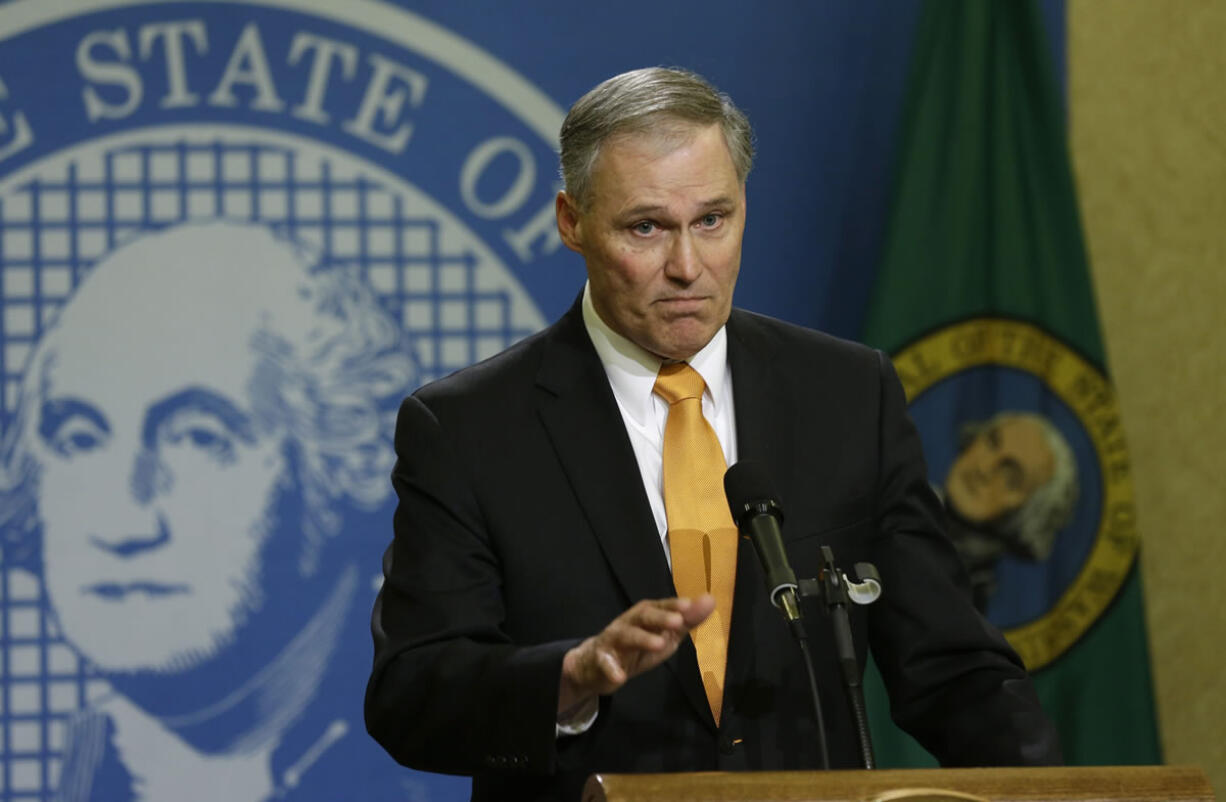 Gov. Jay Inslee talks to reporters late Thursday in Olympia. (TED S.