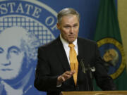 Gov. Jay Inslee talks to reporters late Thursday in Olympia. (TED S.