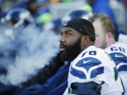 FILE - In this Sunday, Jan. 10, 2016 file photo, Seattle Seahawks tackle Russell Okung (76) sits on the bench during the second half of an NFL wild-card football game against the Minnesota Vikings in Minneapolis. John Elway bolstered both his offensive line and his already strong reputation as one of the NFL?s best general managers Thursday, March 17, 2016 by luring former Seattle Seahawks left tackle Russell Okung to the Denver Broncos.(AP Photo/Nam Y.