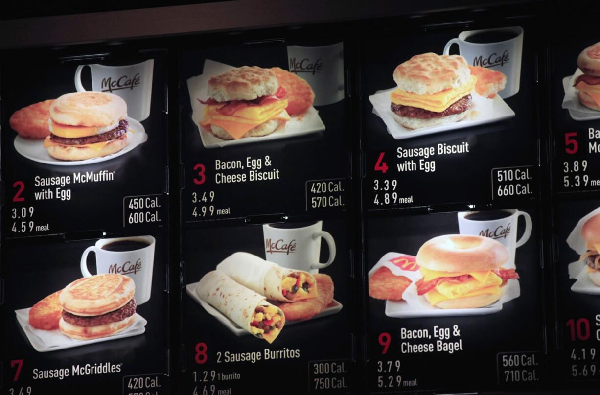 Items on the breakfast menu, including the calories, are posted at a McDonald&#039;s restaurant in New York.