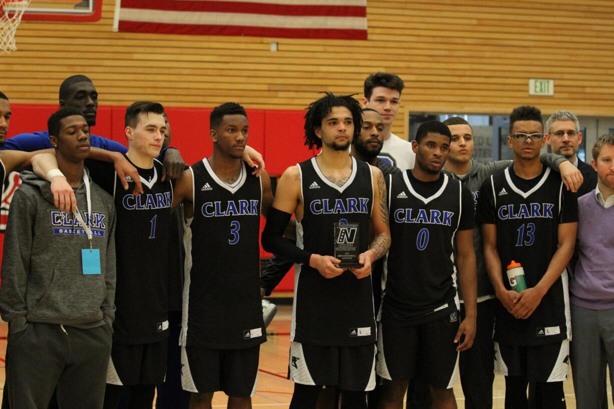 Members of the Clark College men's basketball with the fifth-place NWAC trophy.