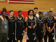 Members of the Clark College men's basketball with the fifth-place NWAC trophy.