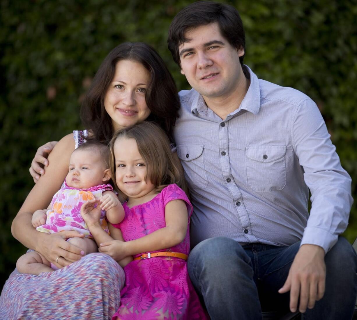 Concert pianist Vadym Kholodenko poses in 2014 with his wife, Sofya Tsygankova, and daughters Nika and Michela at their home in Fort Worth, Texas.