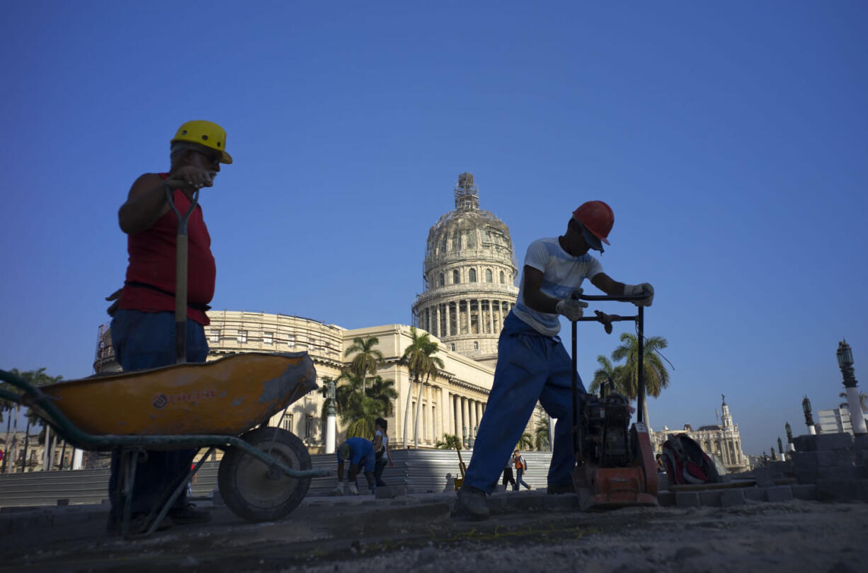 Workers repair the street in front of the Capitolio in Havana, Cuba, Monday, March 14, 2016. U.S. President Barack Obama will travel to Cuba on March 20.