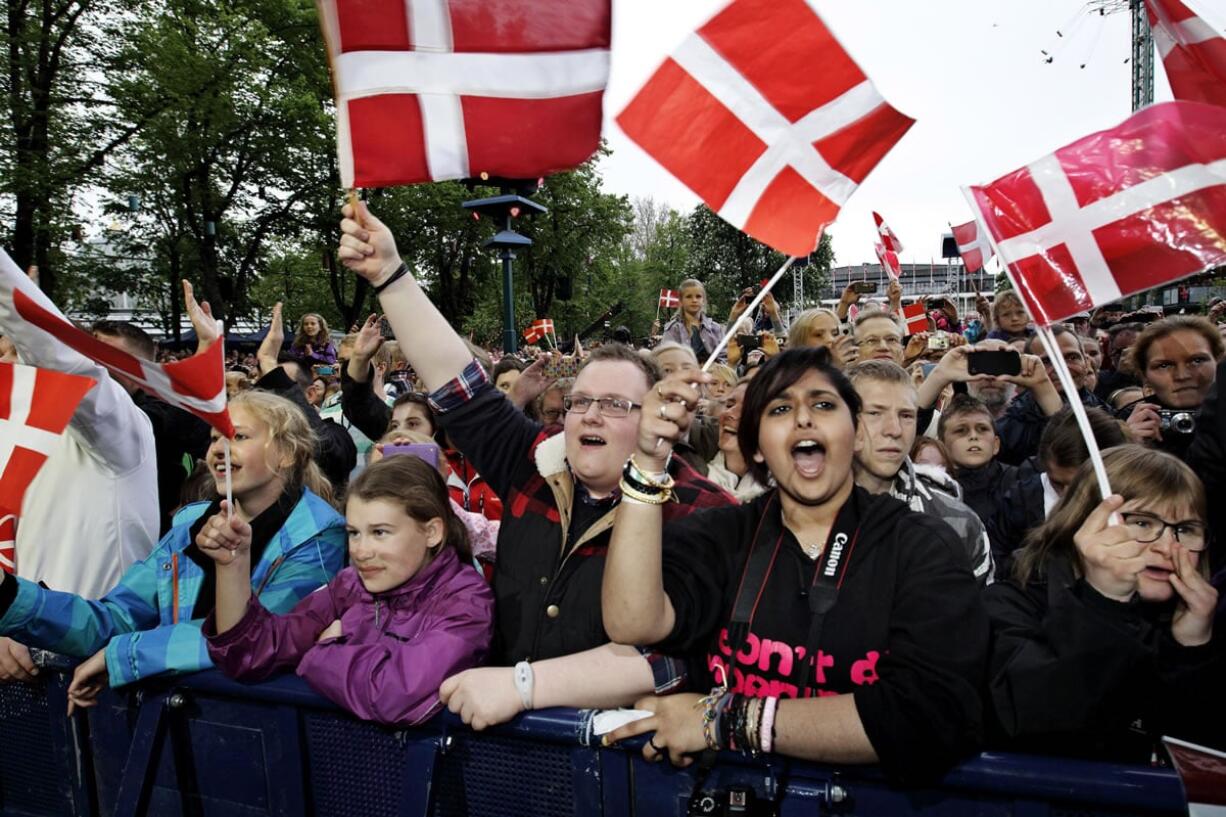 People in Tivoli in Copenhagen Denmark. U.S. Democratic front-runners Hillary Clinton and Bernie Sanders have singled out the small Scandinavian country as an example of a happy, well-oiled society.