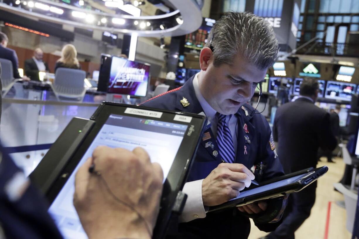 Trader John Panin works on the floor of the New York Stock Exchange on Monday.