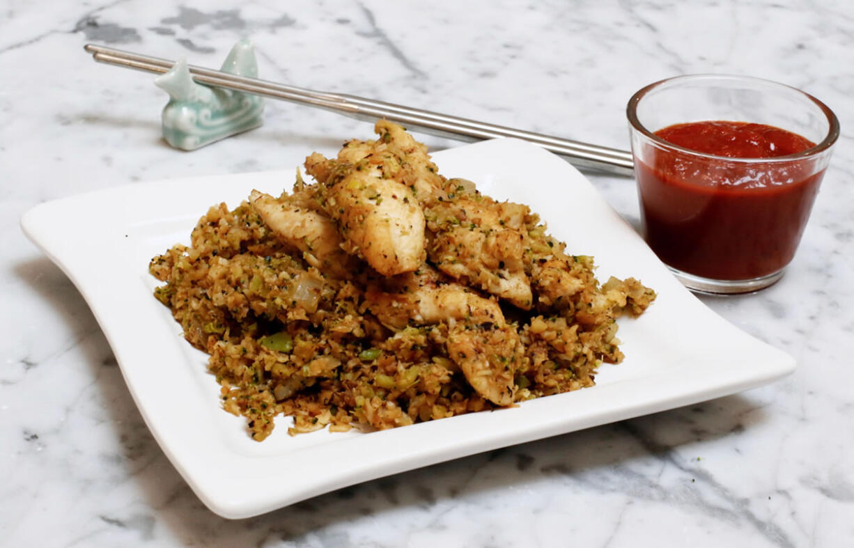 A serving of Italian stir-fry with seared chicken breast and marinara. Finely chopped broccoli and cauliflower stand in for the rice in this vegetable-forward version of the classic Asian dish. (AP Photo/J.M.