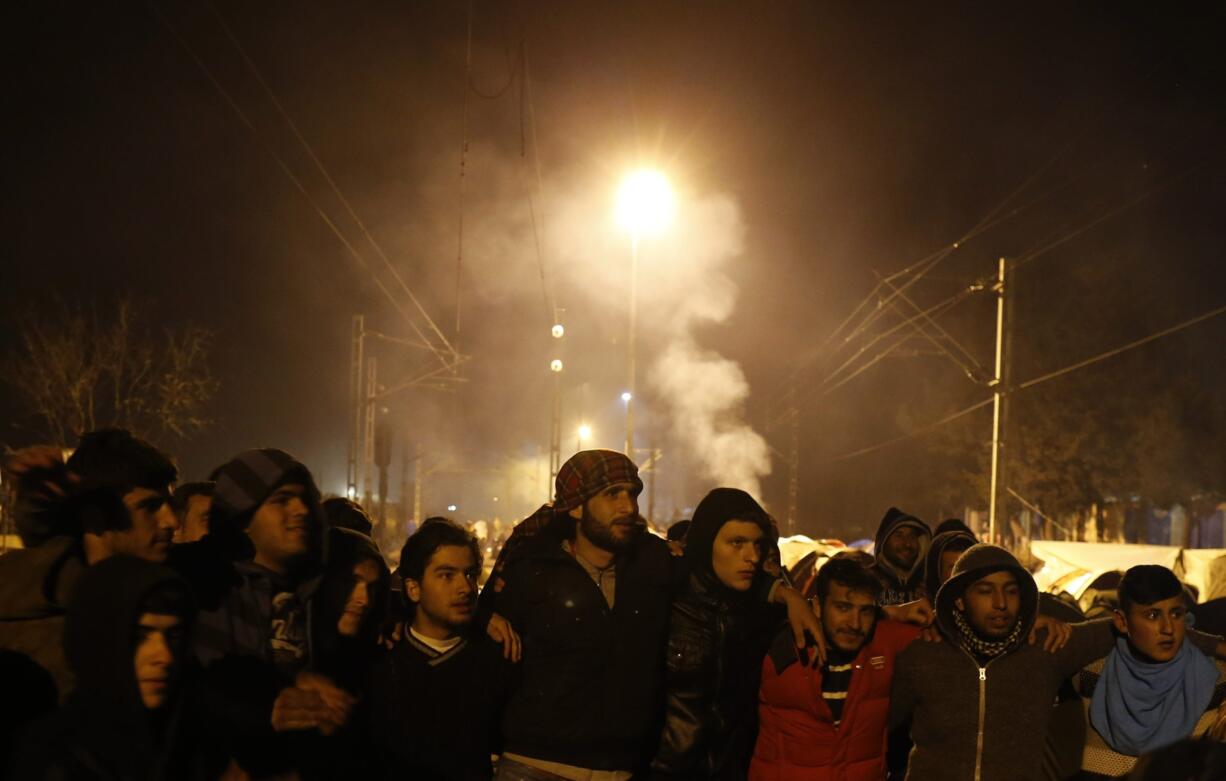 Migrants shout slogans Monday while blocking a railway during the protest demanding the opening of the border between Greece and Macedonia in the northern Greek border station of Idomeni, Greece. The Greek government said Monday it will set up loudspeakers at the country&#039;s border with Macedonia to try and persuade thousands of refugees and migrants to ignore false rumors that the Balkan route to central Europe will reopen.