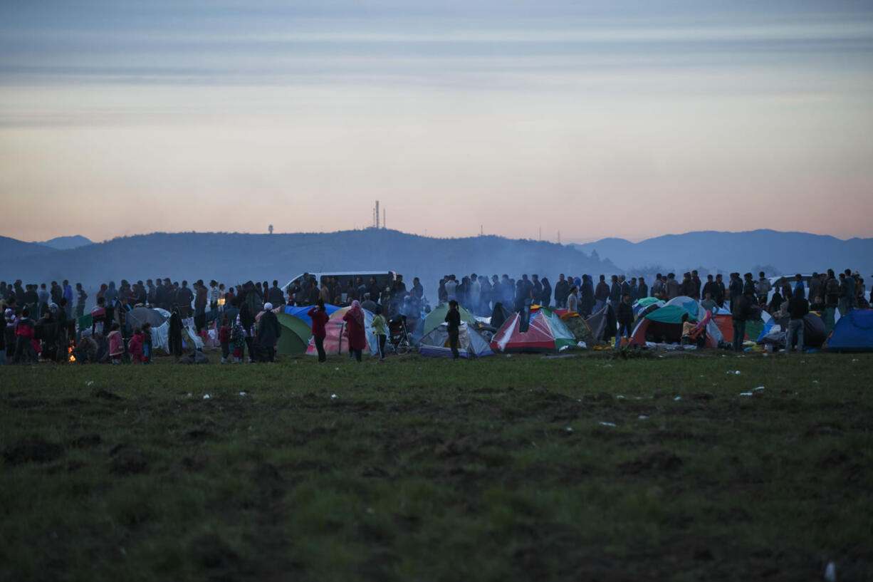 Migrants wait in line for hot soup Tuesday in Idomeni, Greece, along the Greece-Macedonia border.