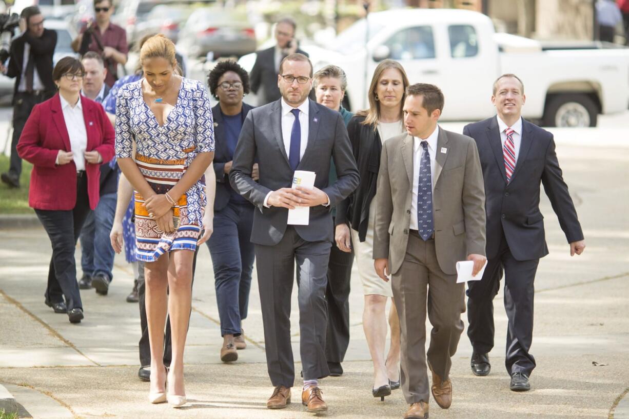 Chad Griffin, center, president of the Human Rights Campaign, walks to the NC state capitol in Raleigh, N.C., on Thursday to deliver a letter signed by major companies to Gov. Pat McCrory urging he and the North Carolina General Assembly repeal the radical provisions of discriminatory House Bill 2 in upcoming legislative session. (Jason E.