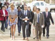 Chad Griffin, center, president of the Human Rights Campaign, walks to the NC state capitol in Raleigh, N.C., on Thursday to deliver a letter signed by major companies to Gov. Pat McCrory urging he and the North Carolina General Assembly repeal the radical provisions of discriminatory House Bill 2 in upcoming legislative session. (Jason E.