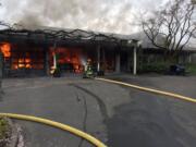 Firefighters are working to extinguish a garage fire at a Camas residence.