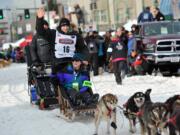 Defending Iditarod Trail Sled Dog Race champion Dallas Seavey (16) waves to the crowd as she begins the ceremonial start of the 1,000-mile race in Anchorage, Alaska, on March 5.