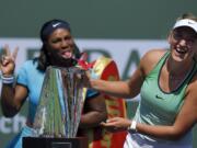 Serena Williams, left, jokes behind Victoria Azarenka, of Belarus, after Azarenka defeated her in a final at the BNP Paribas Open tennis tournament, Sunday, March 20, 2016, in Indian Wells, Calif. Azarenka won 6-4, 6-4. (AP Photo/Mark J.