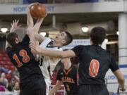 King’s Way Christian High School’s Kienan Walter, center, has his shot blocked by Kalama High School’s Austin Dines in the first half of their game in the boys’ class 1A state basketball tournament March 5, 2016 in the Yakima SunDome in Yakima, Wash.