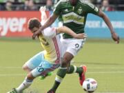 Portland Timbers forward Fanendo Adi (9) and Columbus Crew midfielder Will Trapp (20) battle for the ball during the first half of an MLS soccer match in Portland, Ore., Sunday, March 6, 2016.