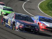 Jimmie Johnson (48) and Joey Logana (22) race for the lead during the late laps of the NASCAR 400 mile auto race Sunday, March 20, 2016, at Auto Club Speedway in Fontana, Calif.