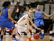 Oregon State guard Jamie Weisner, center, looks for room against DePaul guards Chanise Jenkins (13) and Jessica January (14) during the second half of an NCAA college basketball game in the regional semifinals of the women's NCAA Tournament Saturday, March 26, 2016, in Dallas.