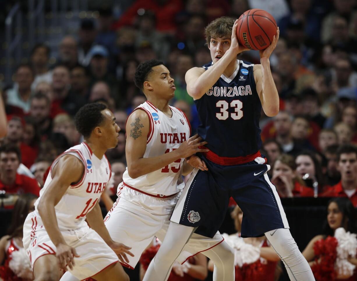 Utah guards Brandon Taylor, left, and Lorenzo Bonam, center, defend Gonzaga forward Kyle Wiltjer during the first half of a second-round men's college basketball game Saturday, March 19, 2016, in the NCAA Tournament in Denver.