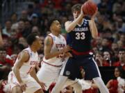 Utah guards Brandon Taylor, left, and Lorenzo Bonam, center, defend Gonzaga forward Kyle Wiltjer during the first half of a second-round men's college basketball game Saturday, March 19, 2016, in the NCAA Tournament in Denver.