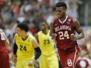 Oklahoma guard Buddy Hield celebrates after scoring during the second half of an NCAA college basketball game against Oregon in the regional finals of the NCAA Tournament, Saturday, March 26, 2016, in Anaheim, Calif.