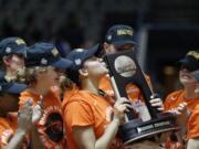 Oregon State forward Deven Hunter, center, kisses the Division I Regional Championship NCAA trophy after a women's NCAA basketball tournament  game against Baylor Monday, March 28, 2016, in Dallas. Oregon State won 60-57.