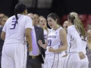 Washington guard Kelsey Plum, center, celebrates with teammates Talia Walton, left, and Alexus Atchley durng the Huskies&#039; win over Penn in the NCAA Tournament.