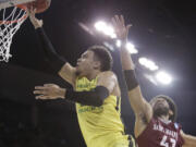 Oregon forward Dillon Brooks, left, shoots against Saint Joseph's forward DeAndre Bembry (43) during the first half of a second-round men's college basketball game in the NCAA Tournament in Spokane, Wash., Sunday, March 20, 2016.