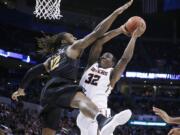 Oregon State forward Jarmal Reid (32) shoots as Virginia Commonwealth forward Mo Alie-Cox (12) defends in the second half of a first-round men's college basketball game in the NCAA Tournament, Friday, March 18, 2016, in Oklahoma City. VCU won 75-67.