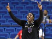 Washington's Chantel Osahor celebrates near the end of  a regional final women's college basketball game in the NCAA Tournament in Lexington, Ky., Sunday, March 27, 2016.