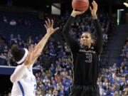 Washington's Talia Walton (3) shoots while defended by Kentucky's Alexis Jennings during a third round women's college basketball game in the NCAA Tournament in Lexington, Ky., Friday, March 25, 2016.