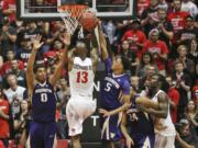 San Diego State forward Winston Shepard has hs shot blocked by Washington guard Dejounte Murray during the first half of an NIT college basketball game Monday, March 21, 2016, in San Diego.