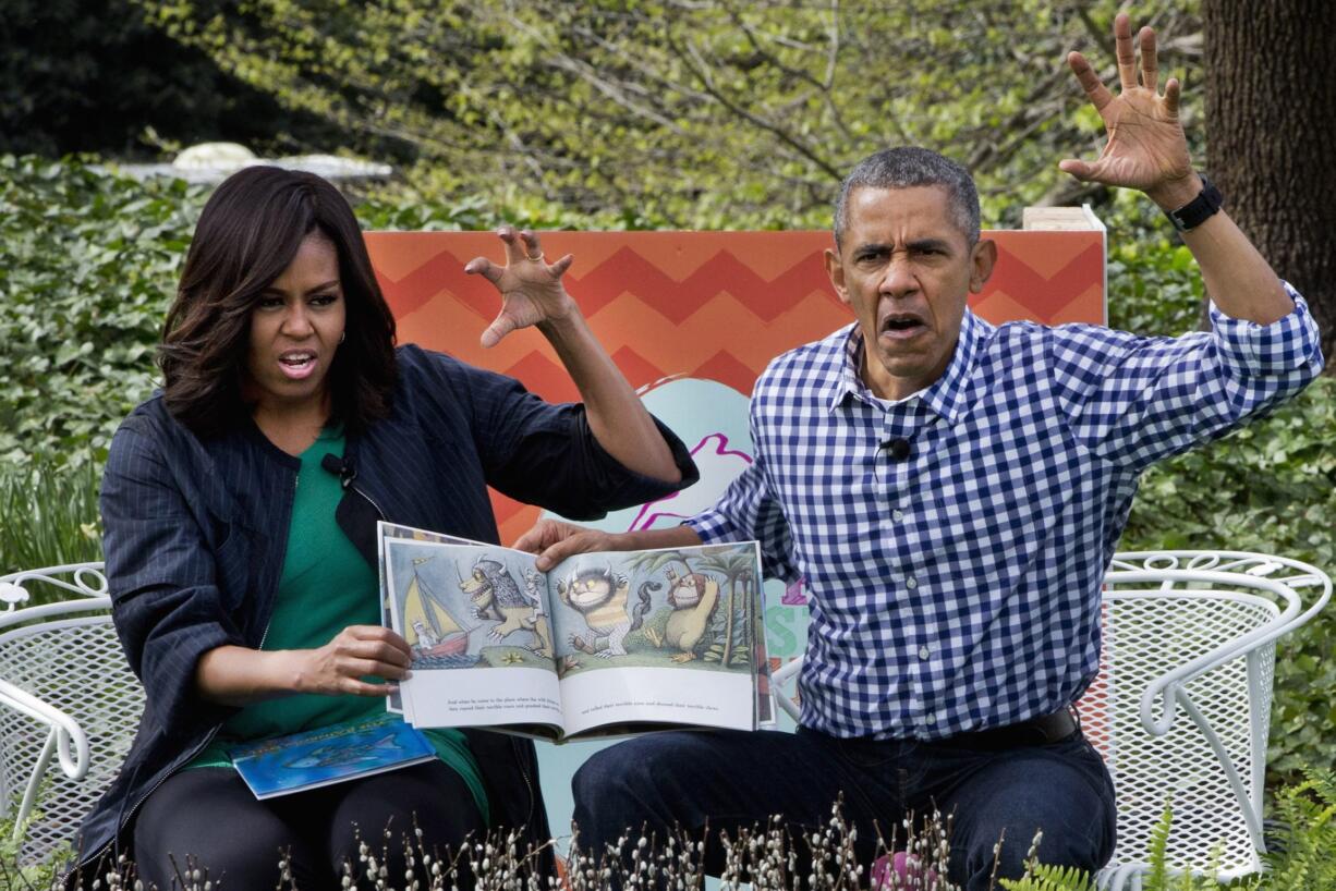 President Barack Obama and first lady Michelle Obama make claw hands and monster faces while reading, &quot;Where The Wild Things Are,&quot; during White House Easter Egg Roll at the White House in Washington on Monday. Thousands of children gathered at the White House for the annual Easter Egg Roll. This year&#039;s event features live music, sports courts, cooking stations, storytelling, and Easter egg rolling.