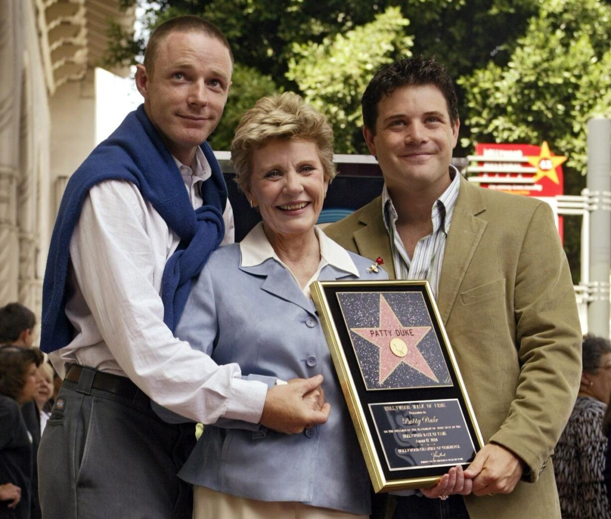 Academy Award winner and television actress Patty Duke poses with her sons, actors Mackenzie Astin, left, and Sean Astin on Aug. 17, 2004, after being honored with a star on the Hollywood Walk of Fame in Los Angeles. Duke, who won an Oscar as a child at the start of an acting career that continued through her adulthood, died Tuesday of sepsis from a ruptured intestine. She was 69.