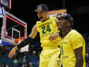 Oregon forward Dillon Brooks (24) and forward Jordan Bell celebrate after they defeated Utah in an NCAA college basketball game in the championship of the Pac-12 men's tournament Saturday, March 12, 2016, in Las Vegas. Oregon won 88-57.