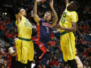 Arizona guard Gabe York (1) shoots between Oregon forwards Dillon Brooks (24) and Chris Boucher (25) during the first half of an NCAA college basketball game in the semifinal round of the Pac-12 men&#039;s tournament Friday, March 11, 2016, in Las Vegas.