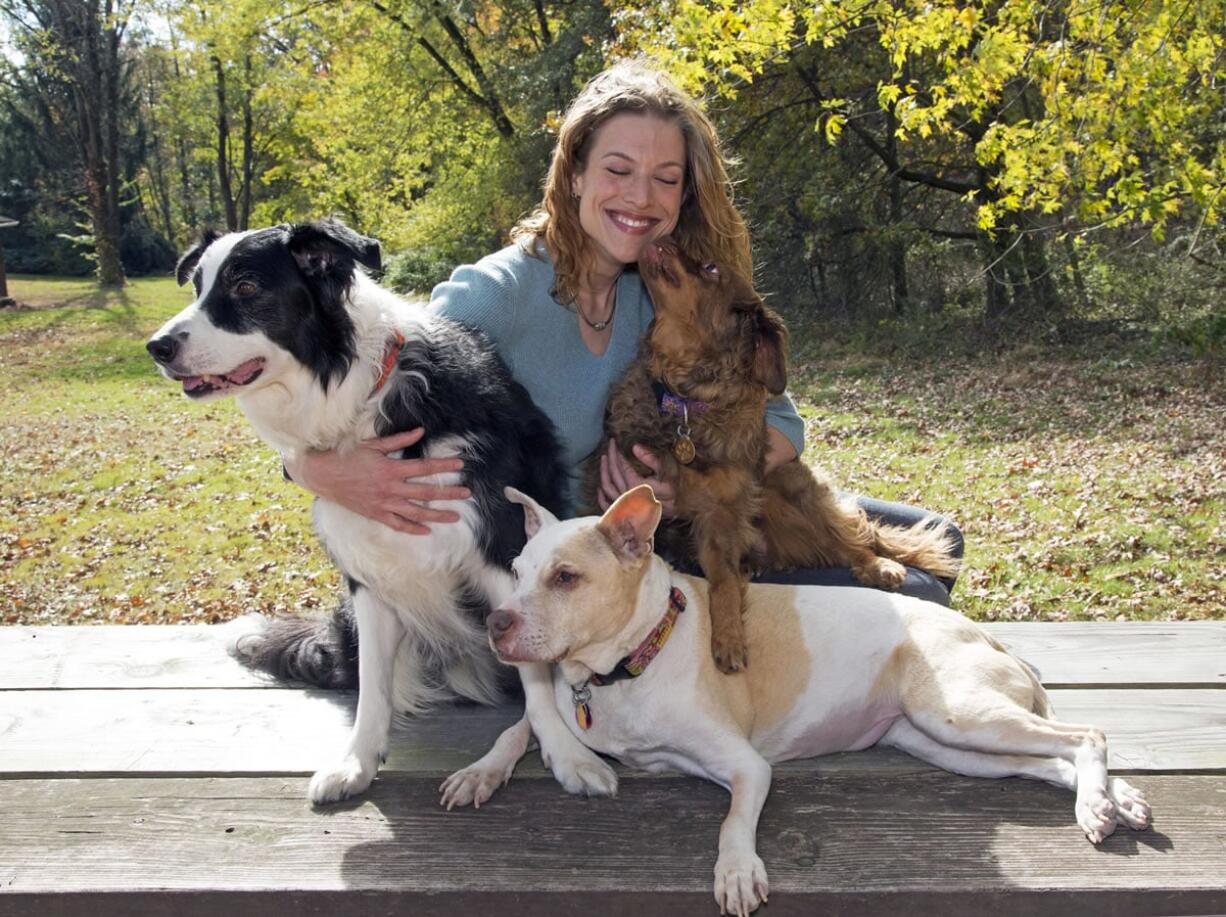 Kristen Collins and her dogs pose in April 2014 for an ASPCA calendar in West Orange, N.J. Collins has been in charge of the ASPCA Behavioral Rehabilitation Center in Madison, N.J., and will do the same when a new center opens next year.