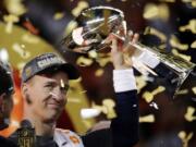 Denver Broncos' Peyton Manning holds up the trophy after the NFL Super Bowl 50 football game in Santa Clara, Calif. A person with knowledge of the decision tells The Associated Press on Sunday, March 6, 2016, that Manning has informed the Denver Broncos he's going to retire. The person, who was briefed on the matter, spoke to The AP on condition of anonymity because the quarterback and the team were still working out details of an announcement.