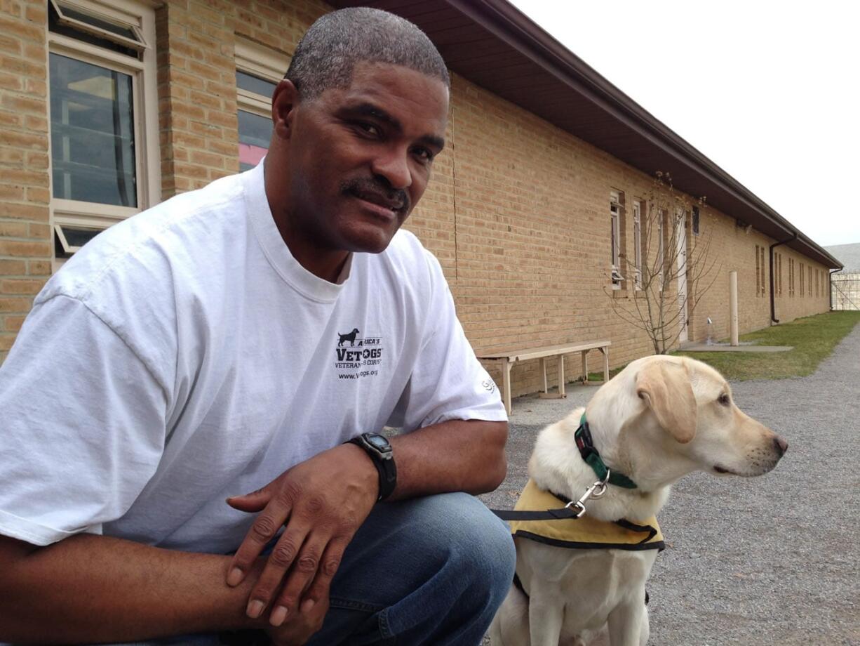 Lee Dorsey, an inmate at the Maryland Correctional Institution-Hagerstown, is seen with River, a yellow Labrador retriever he is training for America&#039;s VetDogs, while at the prison yard in Hagerstown, Md. William Paterson University sociologist Gennifer Furst says more than half of state prison agencies have such programs, and there&#039;s strong demand for more.