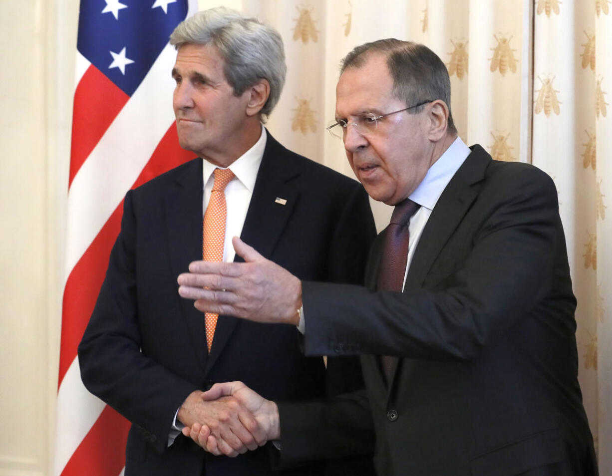 Russian Foreign Minister Sergey Lavrov, right, greets U.S. Secretary of State John Kerry in Moscow, Russia, on Thursday.