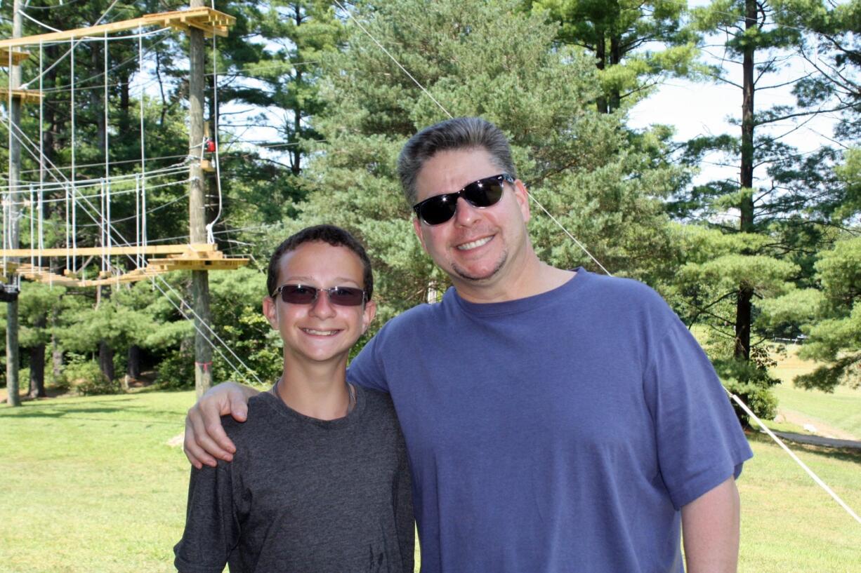 Eric Fiebert gives son Ben a hug on visiting day at Berkshire Hills Eisenberg Camp in Copake, N.Y. Visiting day at summer camps can reignite feelings of homesickness in children, but experts say the day can be fun and stress-free if parents keep the focus on the kids, the day and their activities.