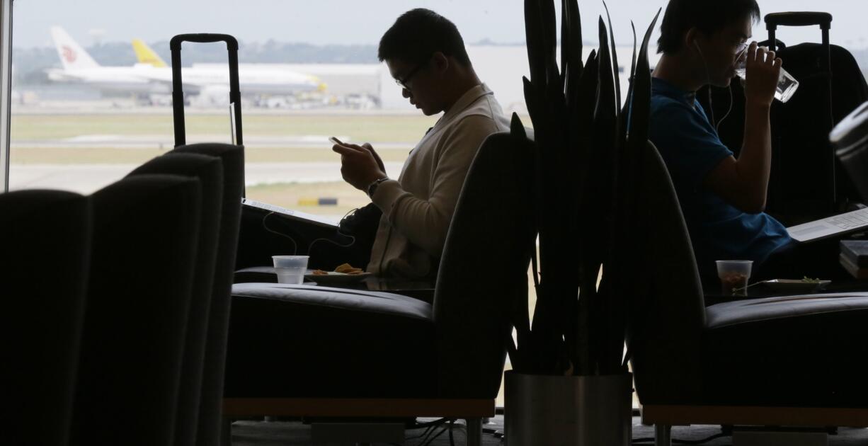 Air travelers wait in the Admiral&#039;s Club at the Dallas-Fort Worth International Airport in Grapevine, Texas. As families and individuals start to book summer travel, a debate is rising about whether airlines make it too hard to choose the most affordable options.