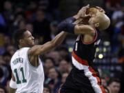 Boston Celtics guard Evan Turner (11) blocks the drive of Portland Trail Blazers guard Gerald Henderson (9) during the first quarter of an NBA basketball game Wednesday, March 2, 2016, in Boston.