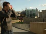 Timelooper co-founder Andrew Feinberg looks through a Google cardboard virtual reality headset across from the Tower of London in London, England, on Feb. 2. The Timelooper app allows users to experience key moments in London history with just a smartphone and a cardboard headset.