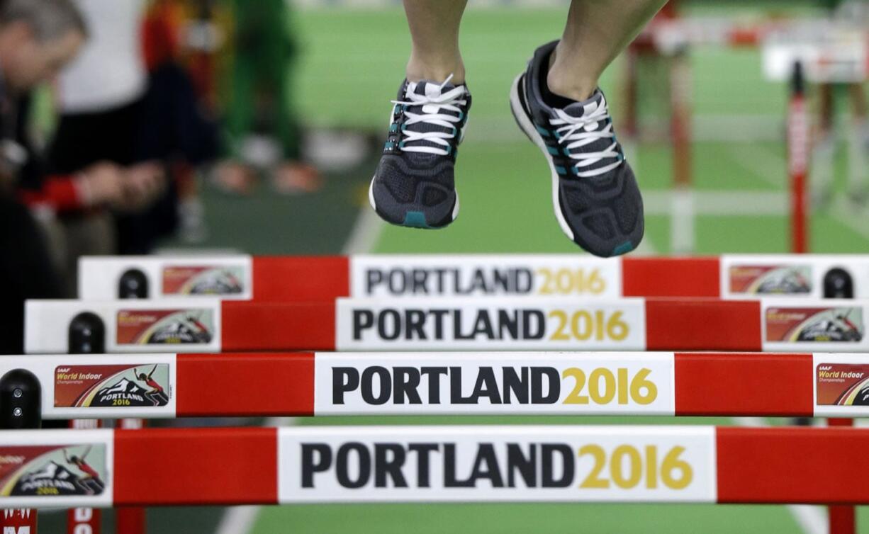 An athlete jumps over hurdles, Wednesday, March 16, 2016, the day before the start of the World Indoor Athletics Championships in Portland, Ore.