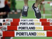 An athlete jumps over hurdles, Wednesday, March 16, 2016, the day before the start of the World Indoor Athletics Championships in Portland, Ore.