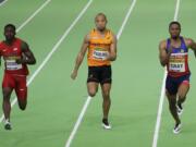 From left, United States' Trayvon Bromell, Netherlands' Hensley Paulina, and Philippines' Eric Cray compete compete in a heat  of the men's 60-meter sprint during the World Indoor Athletics Championships, Friday, March 18, 2016, in Portland, Ore.