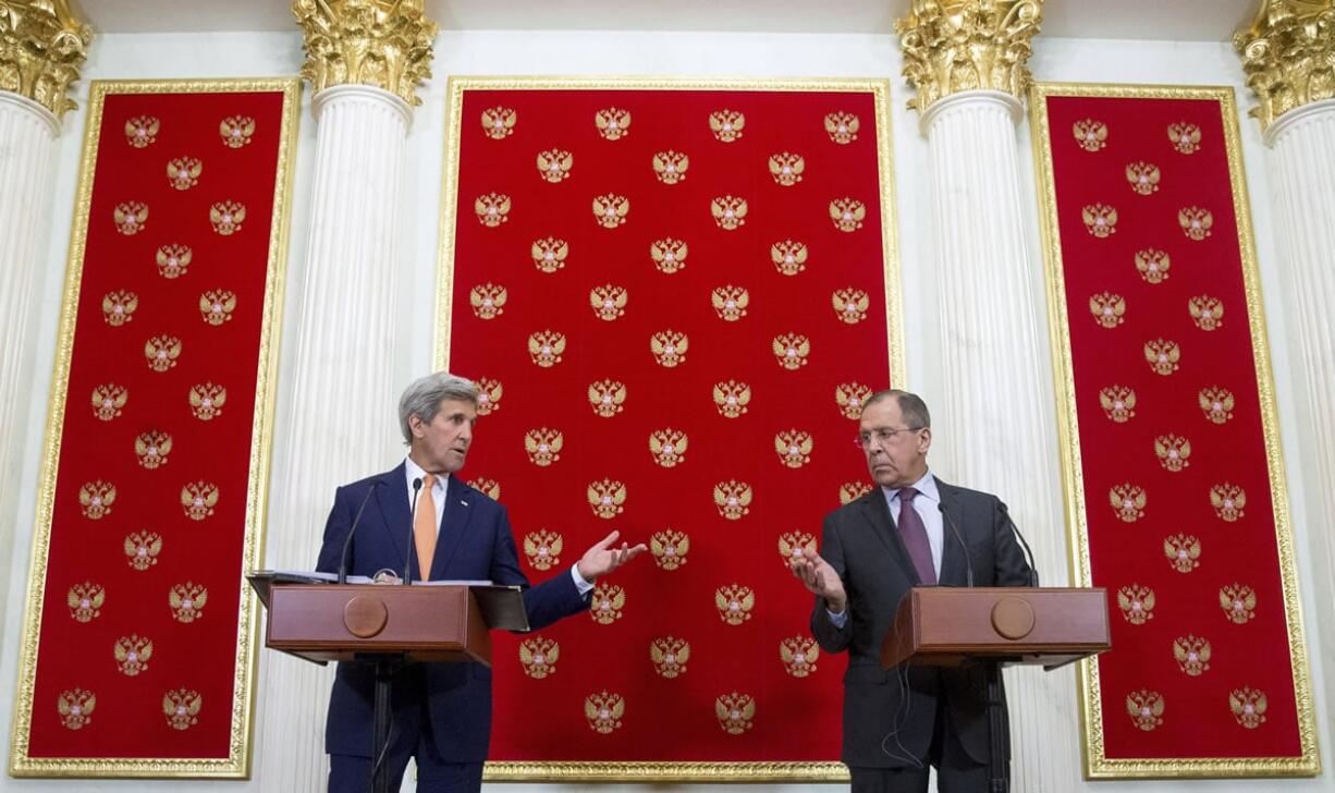 Secretary of State John Kerry and Russian Foreign Minister Sergey Lavrov gesture towards each other to give a chance to answer a question from a member of the media during a news conference at the Kremlin in Moscow, Russia, Friday, March 25, 2016, following a meeting with Russian President Vladimir Putin.