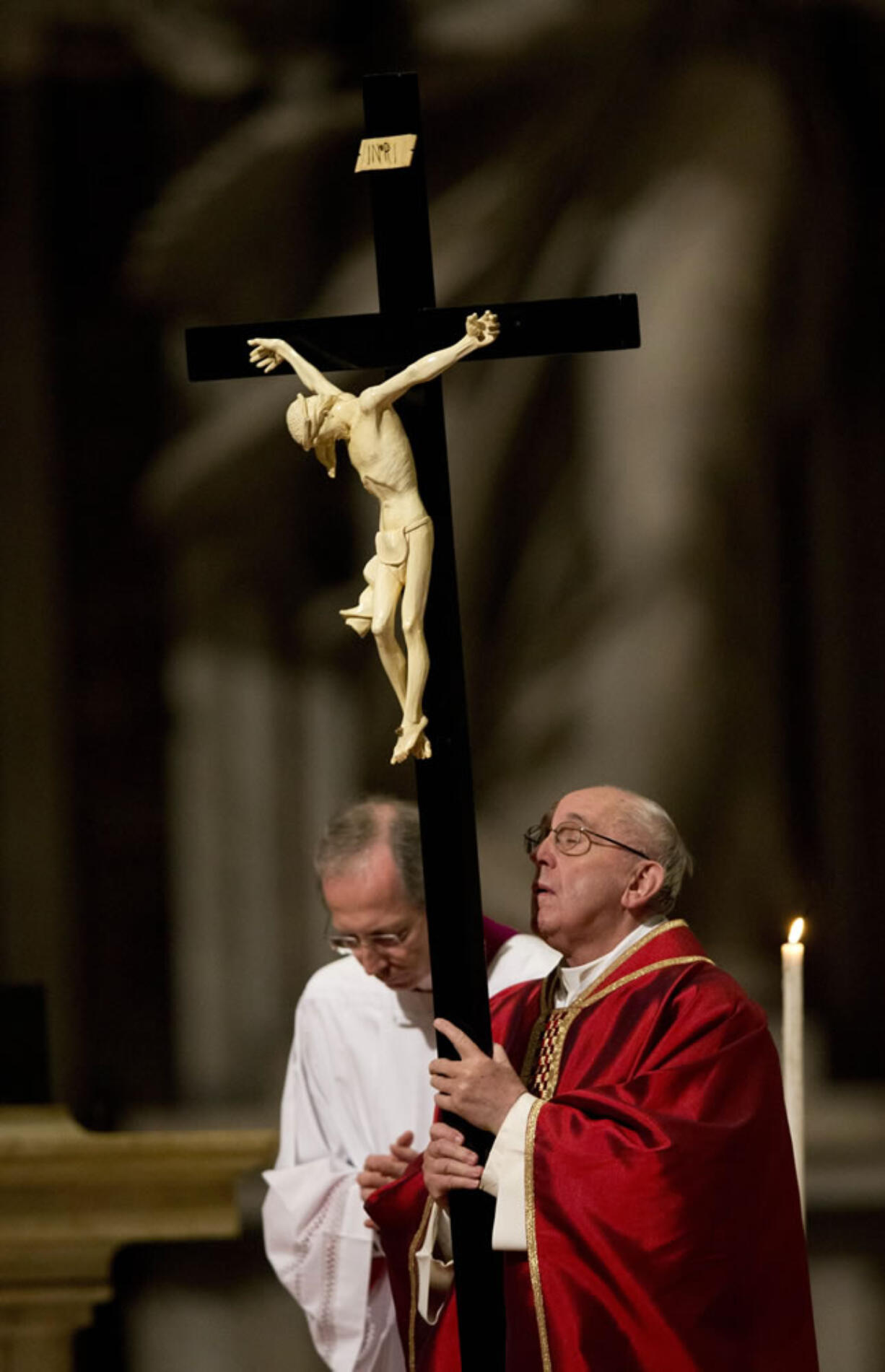 Pope Francis holds the cross during the celebration of the Lord&#039;s Passion on Friday in St. Peter&#039;s Basilica at the Vatican.