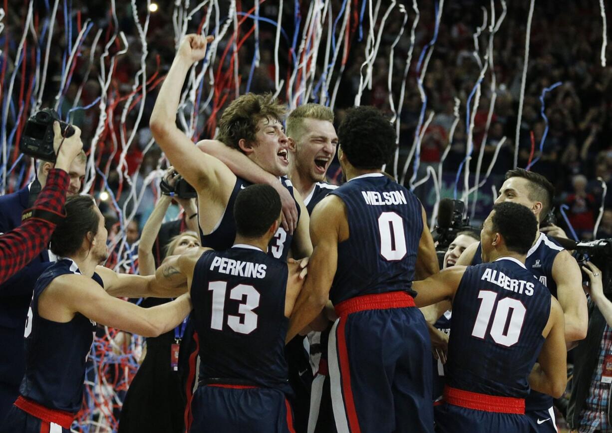 Tournament MVP Gonzaga forward Kyle Wiltjer, top left, celebrates with teammates after defeating Saint Mary's in an NCAA college basketball game for the West Coast Conference men's tournament championship Tuesday, March 8, 2016, in Las Vegas. Gonzaga won 85-75.